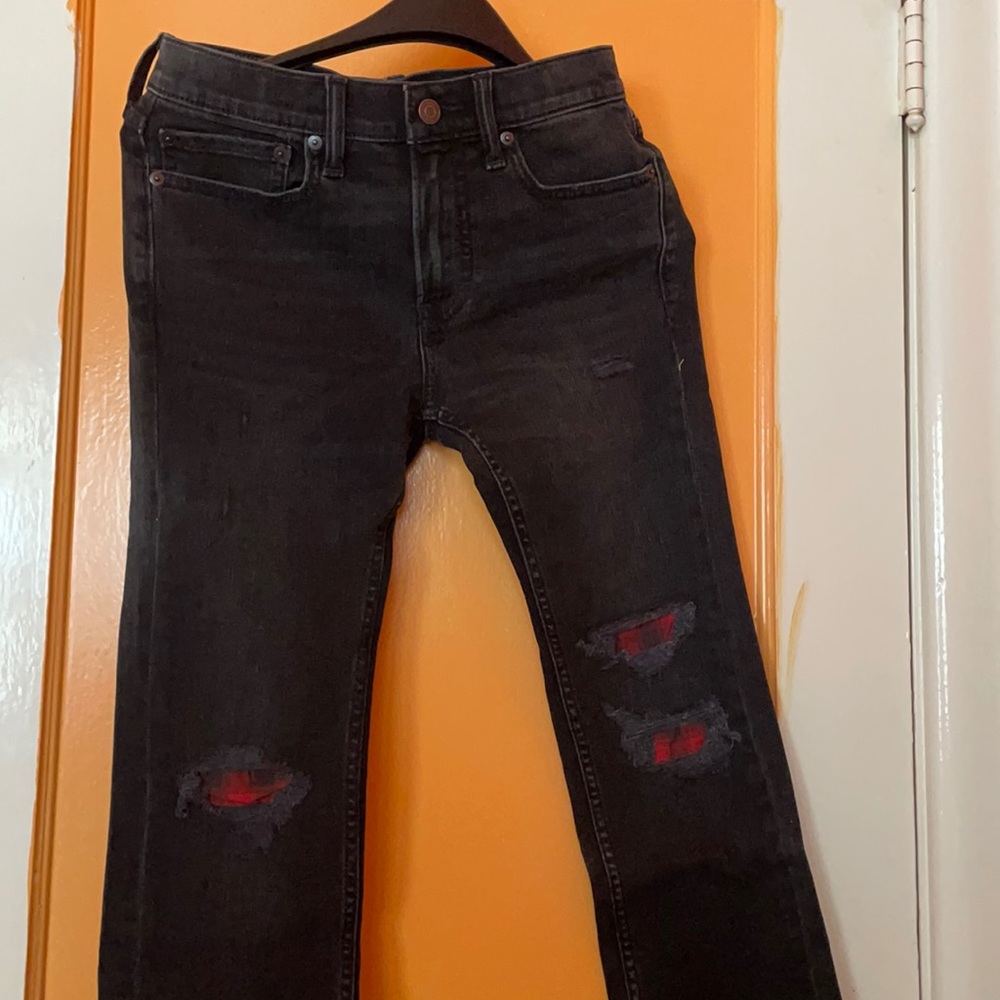 Black Jeans with red & black color on holes, new with tags and never worn.